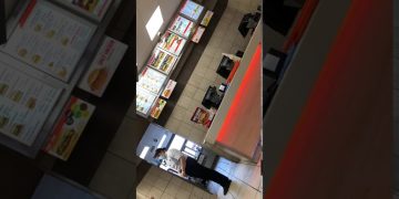 Fast food counter with menu boards and staff.