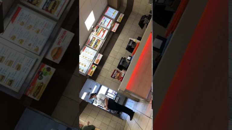 Fast food counter with menu boards and staff.