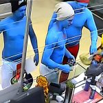 Three blue-painted people at a store checkout