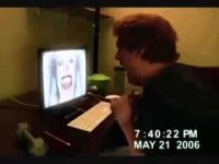 Person startled by a scary image on monitor.