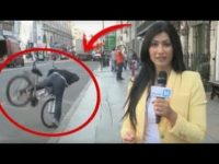 Reporter unaware of cyclist falling in background.