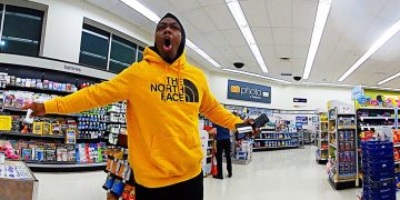 Person in yellow hoodie excited in store.