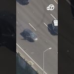 Car driving on highway during police pursuit.