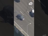 Car driving on highway during police pursuit.