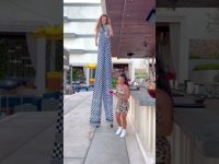 Tall performer on stilts entertaining at outdoor bar