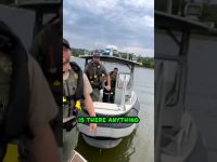 Police officers on a boat with cloudy sky.