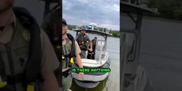 Police officers on a boat with cloudy sky.