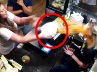 Woman throws food at another in restaurant.