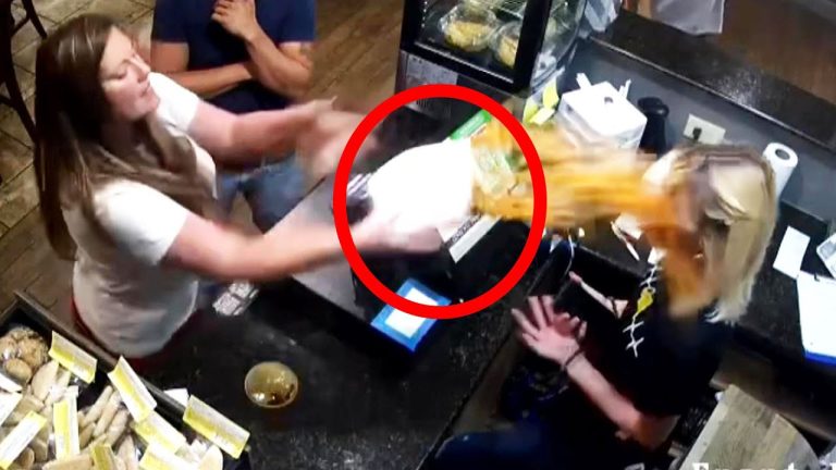 Woman throws food at another in restaurant.