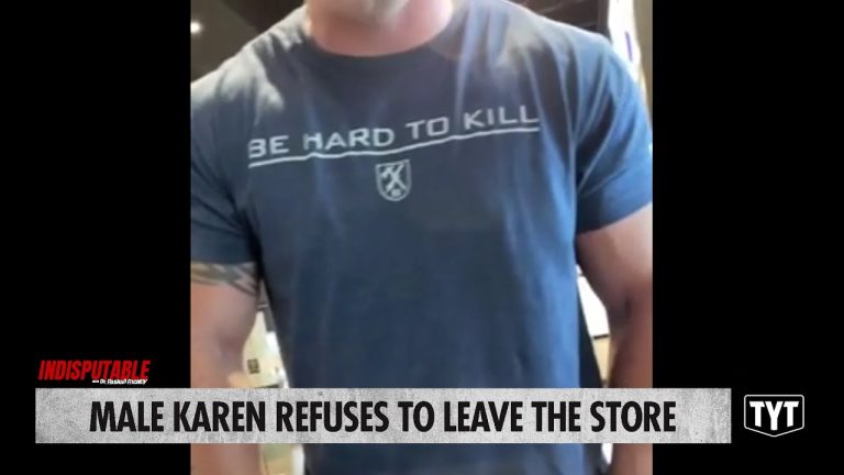 Man in store with 'Be Hard To Kill' shirt.