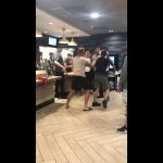 Group of people arguing inside fast-food restaurant.