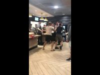 Group of people arguing inside fast-food restaurant.