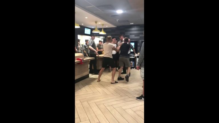 Group of people arguing inside fast-food restaurant.