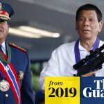 Two men with medals and rifle, 2019 event.