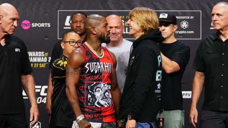 Two fighters facing off at a UFC event.