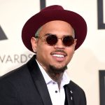 Man in maroon hat and sunglasses at event