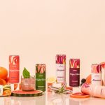 Colorful fruit-infused beverage cans with citrus fruits.