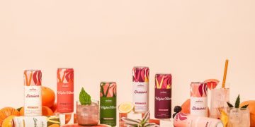 Colorful fruit-infused beverage cans with citrus fruits.