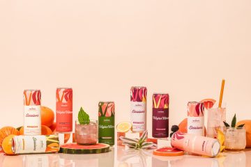 Colorful fruit-infused beverage cans with citrus fruits.