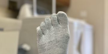 Gray toe sock in a laundry room