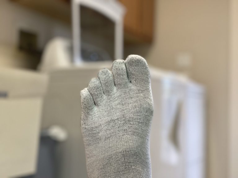 Gray toe sock in a laundry room