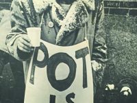 Man holding sign that says 'Pot is Fun'.