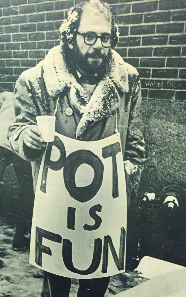 Man holding sign that says 'Pot is Fun'.