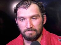 Athlete in red towel during interview.