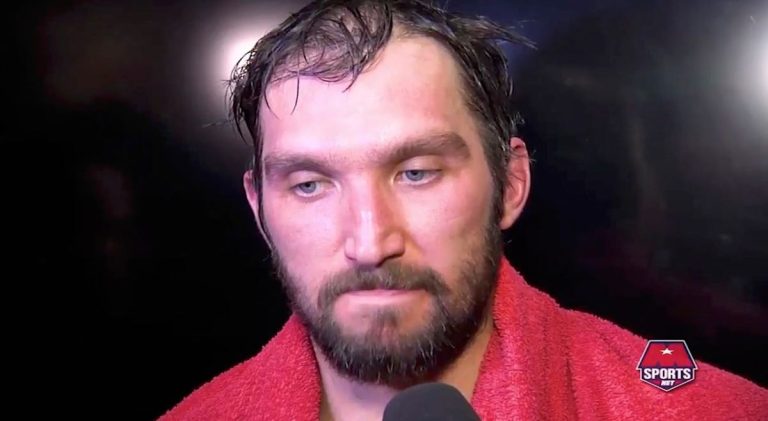 Athlete in red towel during interview.