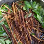 Brew of plants in metal pot