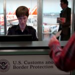 Customs officer working at airport desk