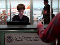 Customs officer working at airport desk