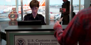 Customs officer working at airport desk