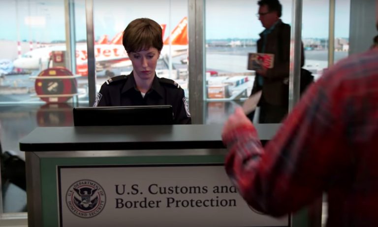 Customs officer working at airport desk