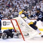 Intense hockey game action near the goal.