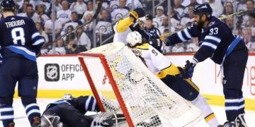 Intense hockey game action near the goal.