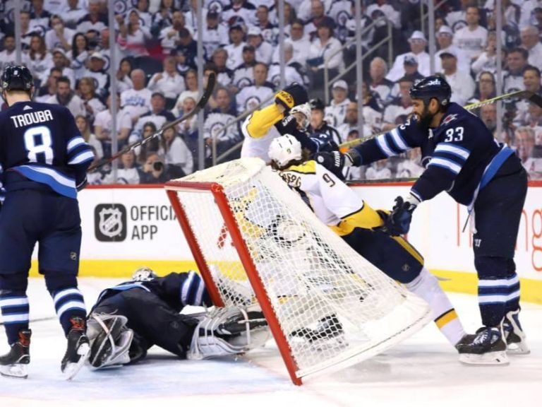 Intense hockey game action near the goal.