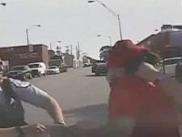 Police confront individual on urban street.